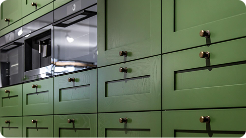 Green painted kitchen cabinets with modern hardware