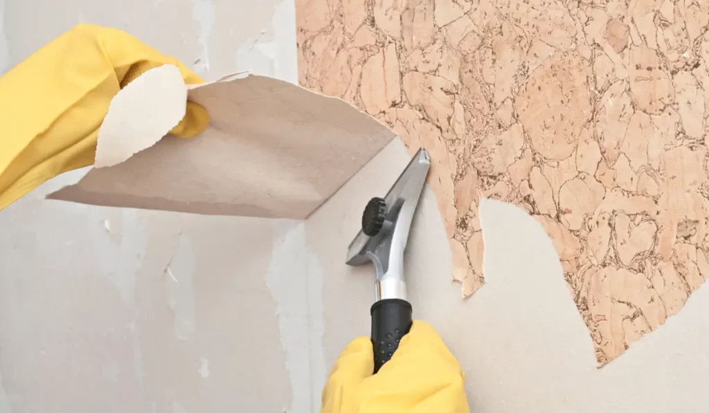 Wallpaper Removal Revealing Damaged Drywall and Adhesive Residue